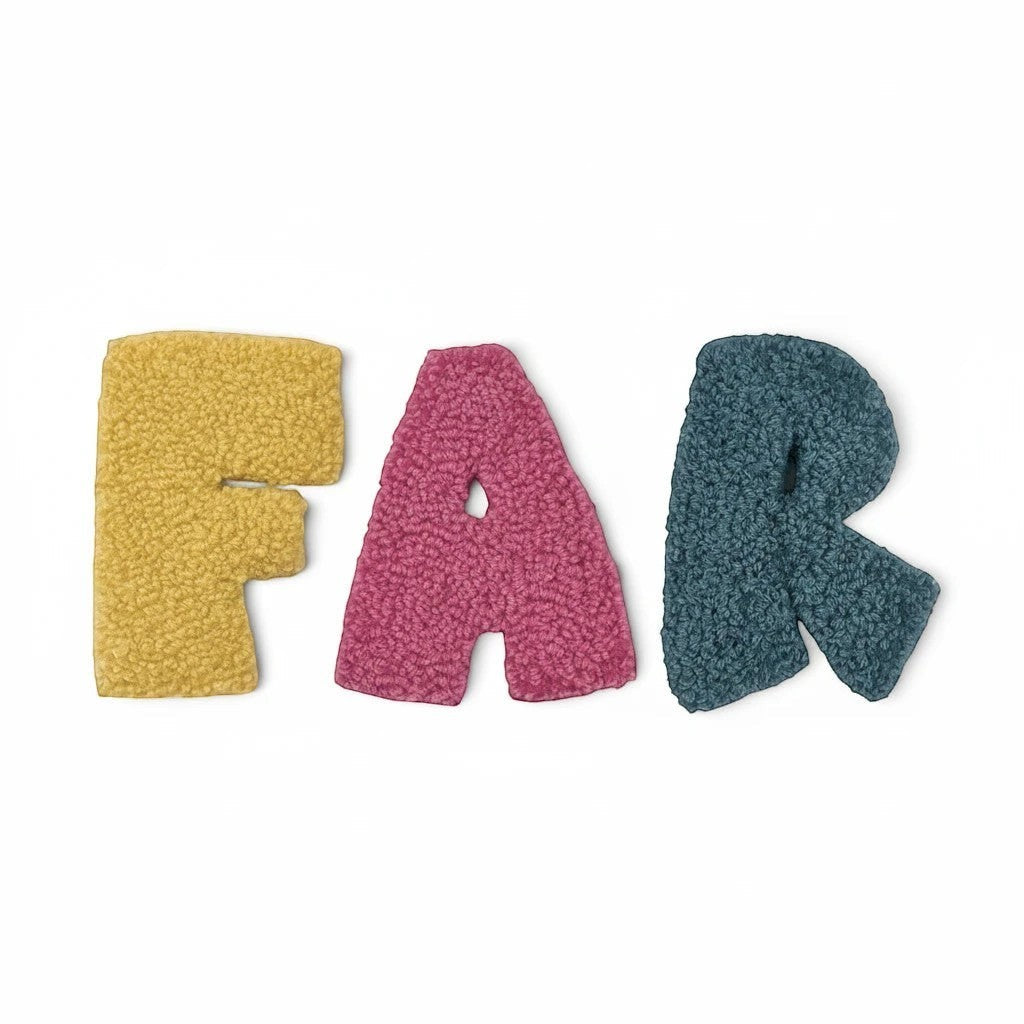 Håndlavet af three tufted letters, F, A, R, in yellow, pink, and teal. Each 14cm letter is made of soft yarn for wall decoration.